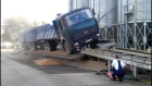 Truck unloads grains on the ramp (грузовик МАЗ высыпает зерна на рампе)